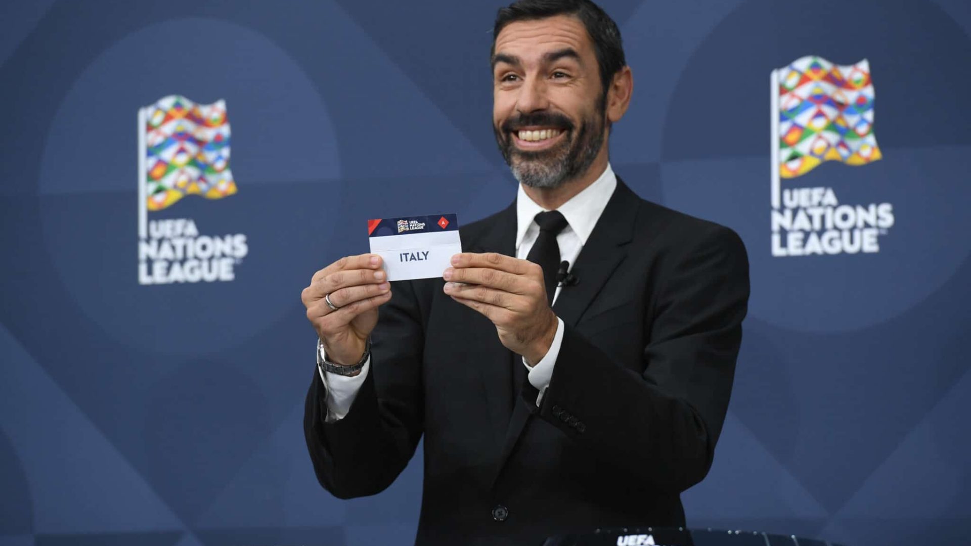 NYON, SWITZERLAND - DECEMBER 16: Special guest Robert Pirès draws out the card of Italy during the UEFA Nations League 2022/23 League Phase Draw at the UEFA headquarters, The House of European Football, on December 16, 2021, in Nyon, Switzerland. (Photo by Richard Juilliart - UEFA/UEFA via Getty Images)